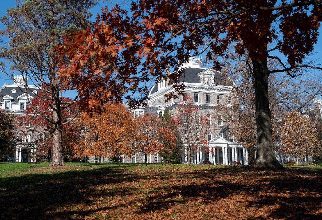 image of a campus building with trees in the foreground with leaves turning orange.