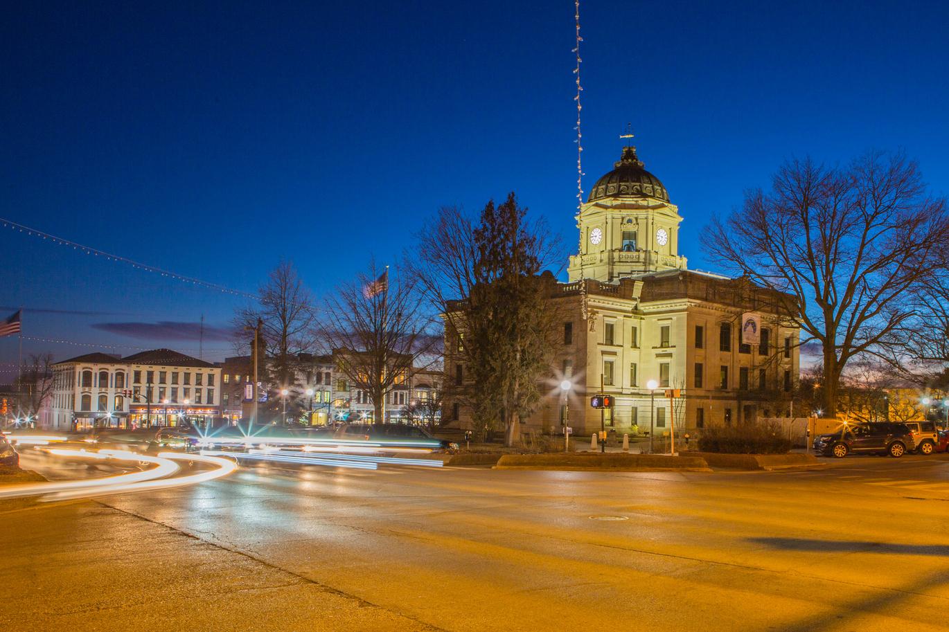 an image of Bloomington's courthouse and courthouse square square at dusk